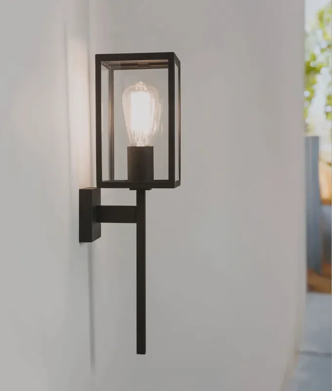 Contemporary coach lantern with a black metal frame and clear glas